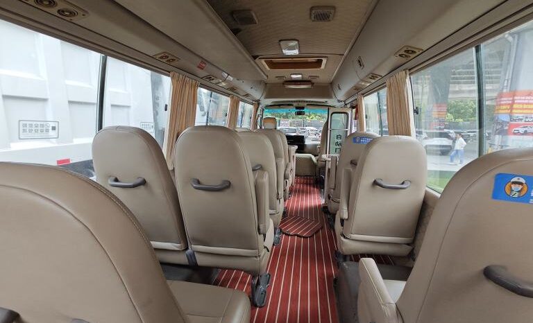 
								Toyota Coaster, a medium-sized bus full									