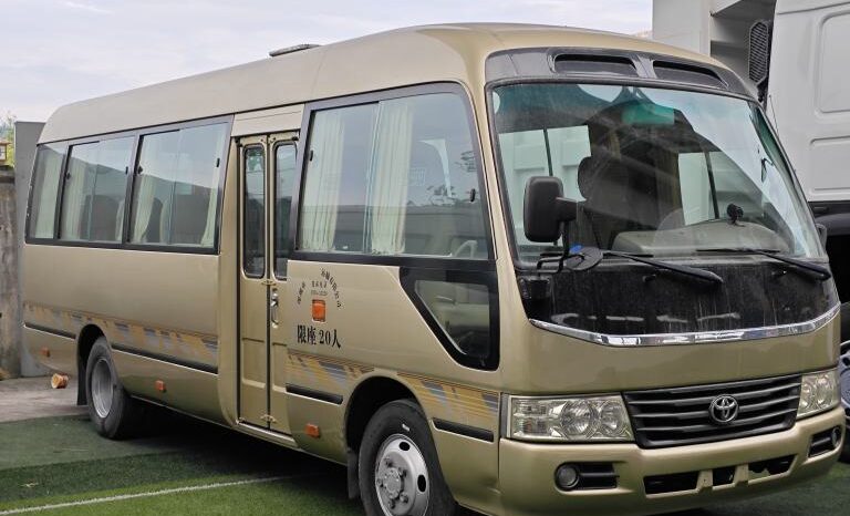 
								Toyota Coaster, a medium-sized bus full									