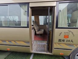 
										Toyota Coaster, a medium-sized bus full									