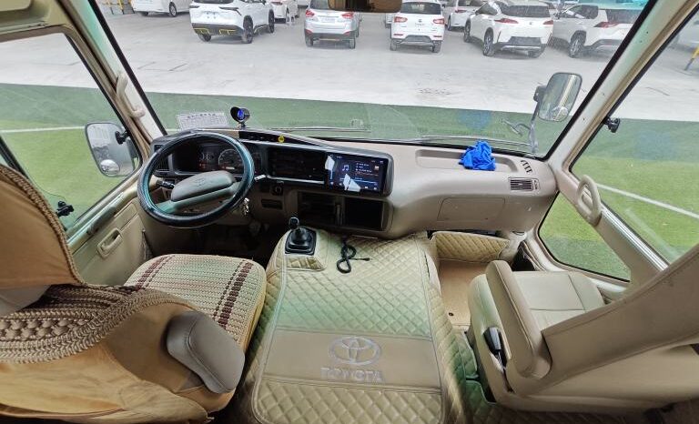 
								Toyota Coaster, a medium-sized bus full									